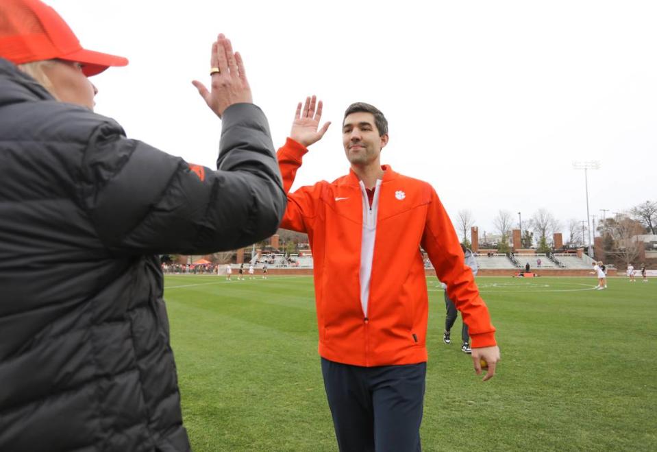 Clemson director of athletics Graham Neff gives lacrosse head coach Allison Kwolek a high five prior to the inaugural game against the Wofford Terriers on Saturday at Historic Riggs Field.