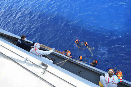 Migrants from a capsized boat are rescued during a rescue operation by Italian navy ships "Bettica" and "Bergamini" off the coast of Libya in this handout picture released by the Italian Marina Militare on May 25, 2016. Marina Militare/Handout via REUTERS