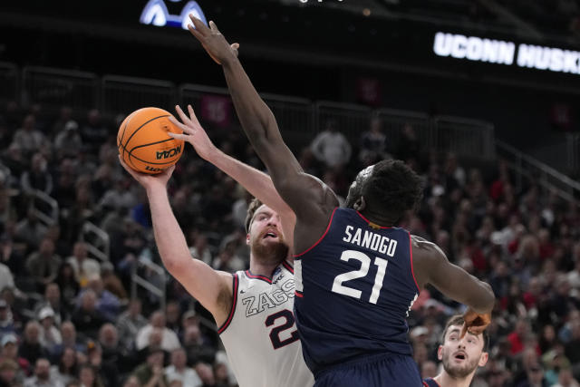 Gonzaga forward Drew Timme shoots while defended by UConn forward Adama Sanogo (21) in the first half of an Elite 8 college basketball game in the West Region final of the NCAA Tournament, Saturday, March 25, 2023, in Las Vegas. (AP Photo/John Locher)