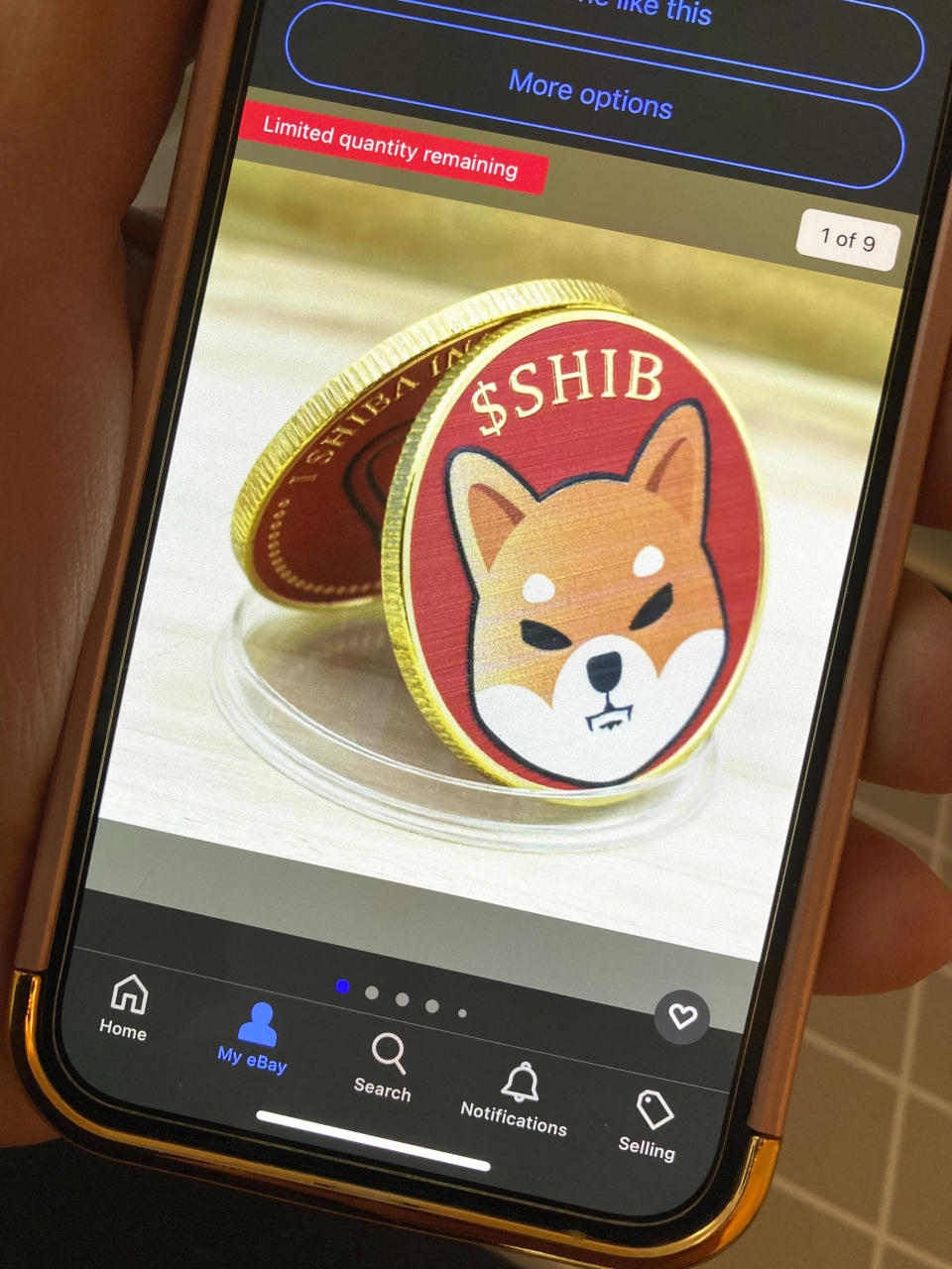 A photo of a phone showing Shiba Inu commemorative coins for sale on ebay.