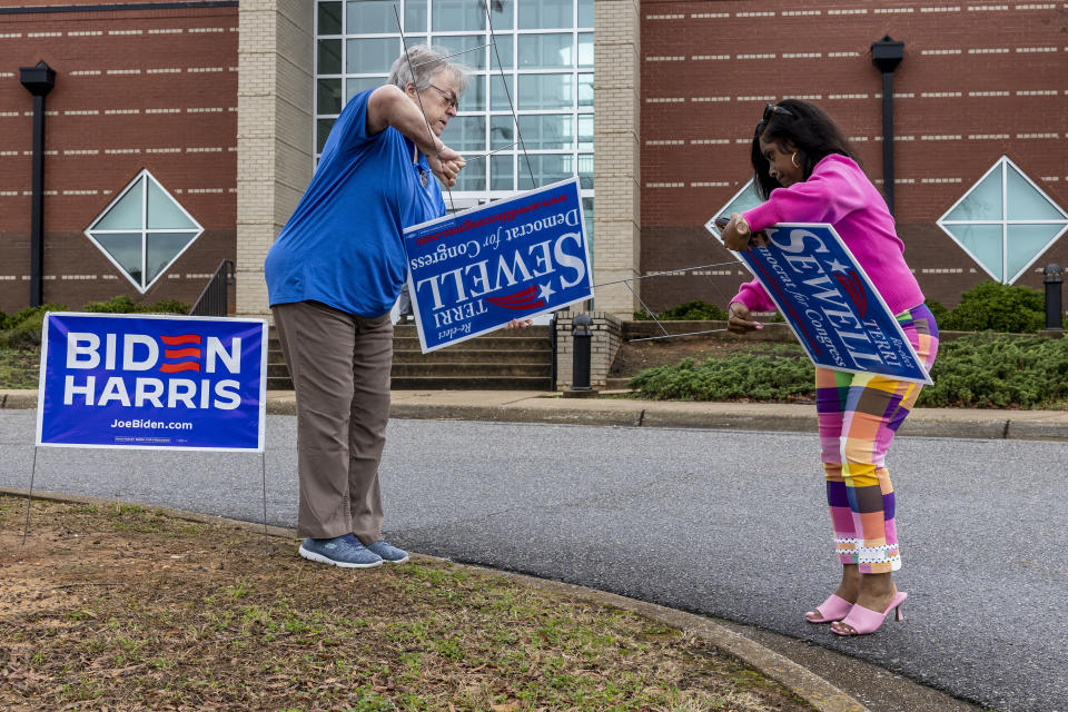 Judy Taylor, left, chair of the Tuscaloosa County Democratic Party, and Donna Foster, chair of the Tuscaloosa Chapter Alabama Democratic Conference, prepare signs for the Biden Harris campaign and Democratic U.S. Rep. Terry Sewell, during a primary election, Tuesday, March 5, 2024, at the Tuscaloosa County Ward 47 Bobby Miller Activity Center in Tuscaloosa, Ala. Fifteen states and a U.S. territory hold their 2024 nominating contests on Super Tuesday this year. (AP Photo/Vasha Hunt)