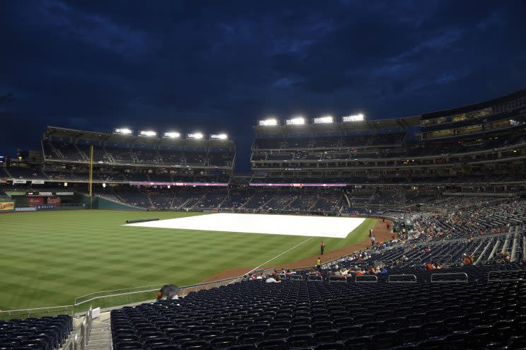 The tarp lies on the field during a delay before a baseball game between the Washington Nationals and the Atlanta Braves, Thursday, July 6, 2017, in Washington. (AP Photo/Nick Wass)