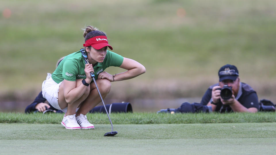 In this Sunday, Jan. 19, 2020 photo, Gaby Lopez looks over the green before her putt during a playoff in the Tournament of Champions LPGA golf tournament in Lake Buena Vista, Fla. Lopez ran in a 30-foot putt for birdie Monday, Jan. 20, 2020, to defeat Nasa Hataoka in a seven-hole playoff that took an extra day to finish after play was halted Sunday because of darkness. (AP Photo/Gary McCullough, File)