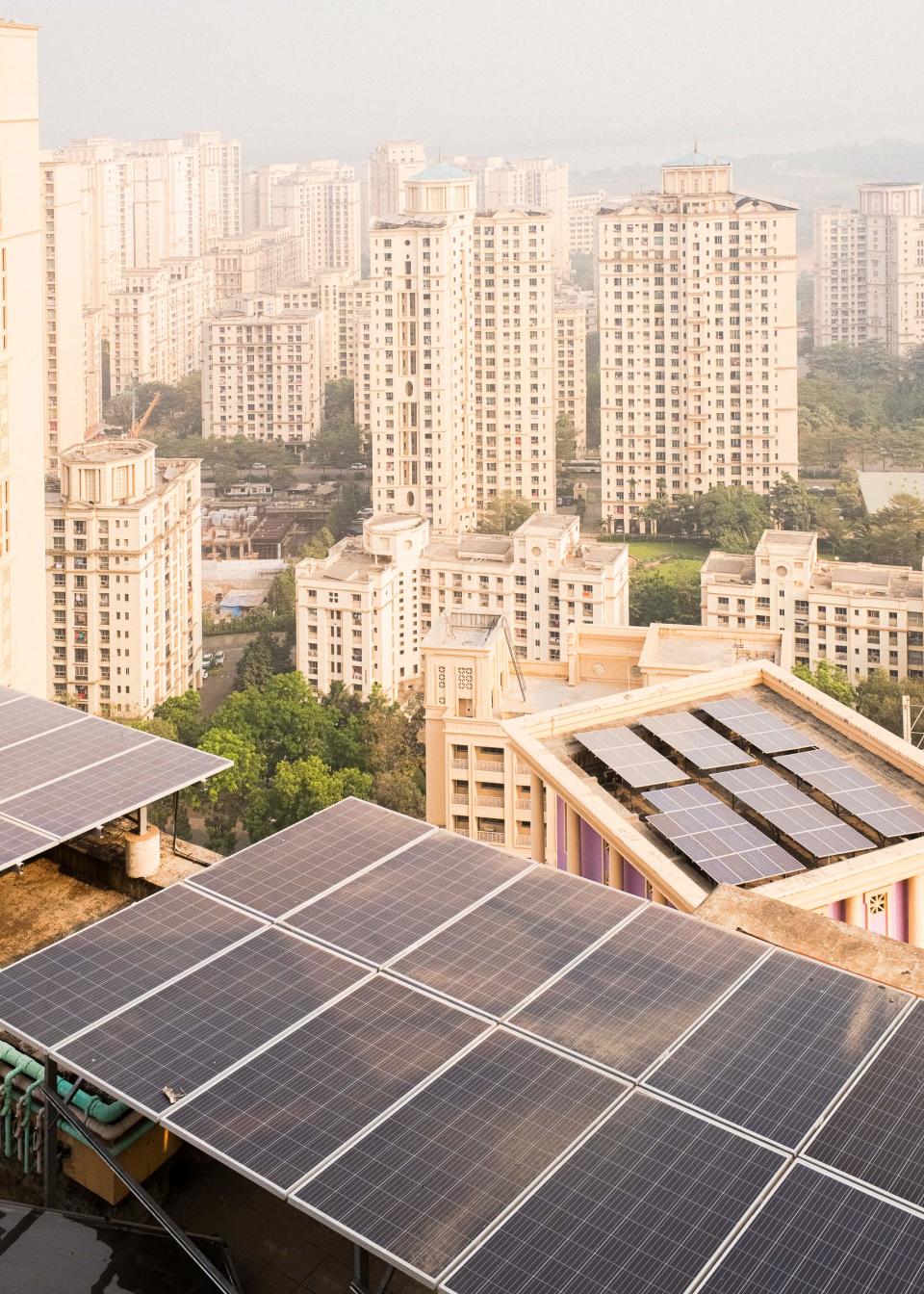 Solar panels installed by Koku Solar Pvt. Ltd line the rooftops of residential buildings in Mumbai, allowing them to run using green energy.<span class="copyright">Sarker Protick for TIME</span>