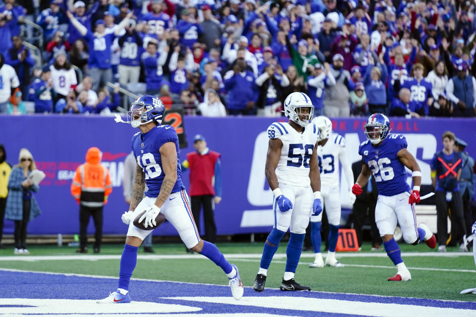 New York Giants wide receiver Isaiah Hodgins (18) celebrates after scoring a touchdown during the first half of an NFL football game against the Indianapolis Colts, Sunday, Jan. 1, 2023, in East Rutherford, N.J. (AP Photo/Seth Wenig)