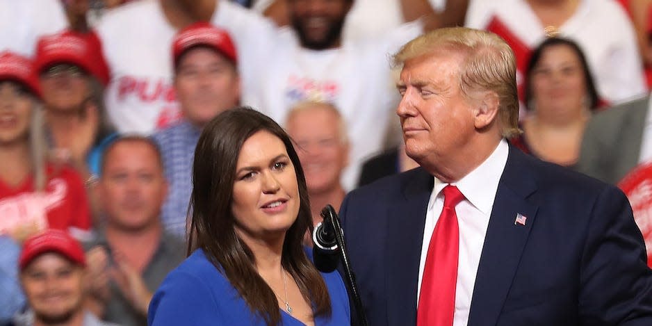 President Donald Trump stands with Sarah Huckabee Sanders, who announced that she is stepping down as the White House press secretary, during his rally where he announced his candidacy for a second presidential term at the Amway Center on June 18, 2019 in Orlando, Florida..