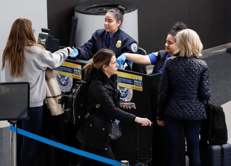 Travelers go through a security check point during the Thanksgiving holiday travel rush at O'Hare Airport in Chicago