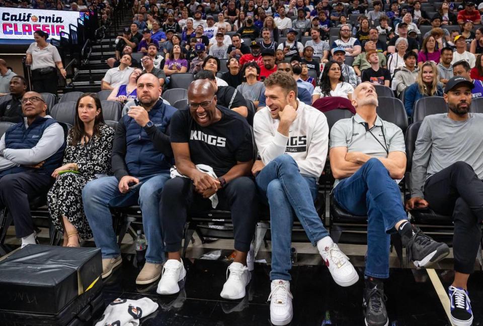EuroLeague MVP and incoming Sacramento King Sasha Vezenkov, right of center, shares a laugh with Sacramento Kings head coach Mike Brown, as they are flanked by more Kings staff, after the third quarter as Luke Loucks coaches the Kings in their California Classic NBA summer league basketball game win over the Miami Heat on Wednesday, July 5, 2023, at Golden 1 Center.