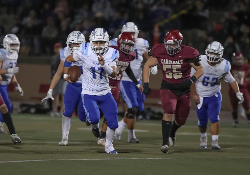 Fillmore quarterback David Jimenez gets away from the Santa Paula defense during their rivalry game on Sept. 29.