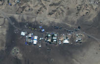 This satellite image taken Sunday, Nov. 22, 2020 and released by Maxar Technologies, shows Ethiopian refugees gathered at a transit center in the border town of Hamdayet, in eastern Sudan. Ethiopia's prime minister is rejecting growing international consensus for dialogue and a halt to deadly fighting in the Tigray region as "unwelcome," saying his country will handle the conflict on its own as a 72-hour surrender ultimatum runs out on Wednesday. (Maxar Technologies via AP)