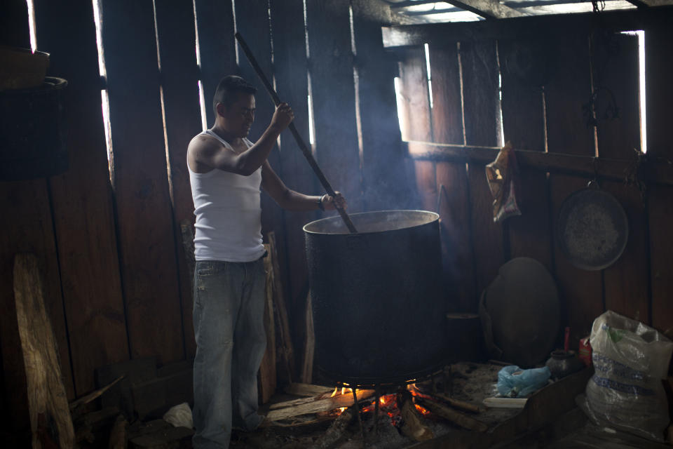 In this Feb. 11, 2014 photo, Margarito de la Cruz, 26, boils corn for tortilla dough at his home in Cochoapa El Grande, Mexico. Since independence more than two centuries ago, Mexico has suffered from persistently high levels of poverty and economic inequality, but Mexico's President Enrique Pena Nieto is the first president to focus so intently on hunger, which his administration calls the most pressing problem facing the country’s poorest citizens. (AP Photo/Dario Lopez-Mills)