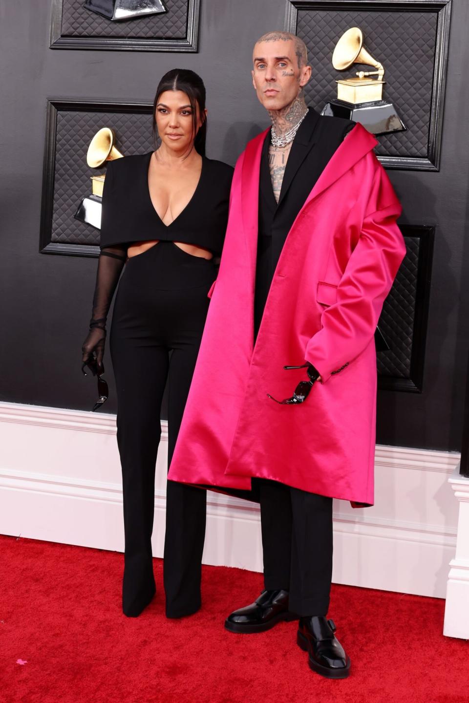 Kourtney Kardashian and Travis Barker 2022 Grammys Red Carpet Pink Jacket Black jumpsuit