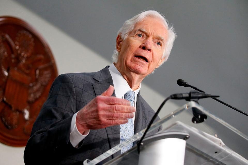 Republican Sen. Thad Cochran of Mississippi, his right hand raised to chest level, speaks to reporters from behind a podium during a Capitol Hill press conference in June 2017.