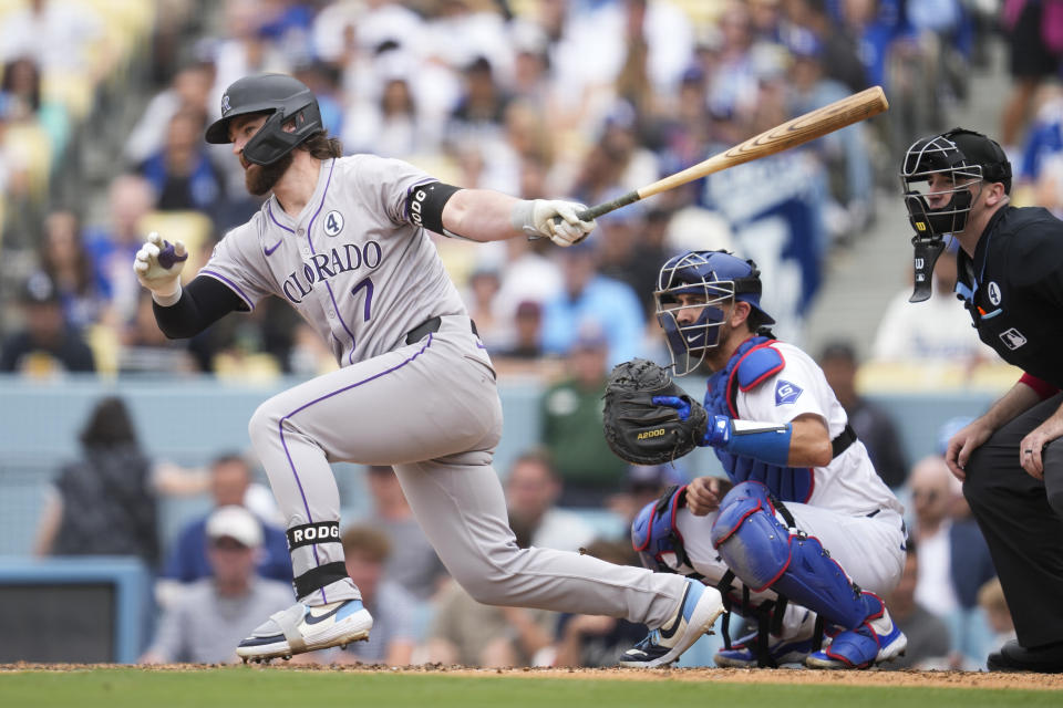 Colorado Rockies designated hitter Brendan Rodgers (7) grounds into a double play during the sixth inning of a baseball game against the Los Angeles Dodgers in Los Angeles, Sunday, June 2, 2024. (AP Photo/Ashley Landis)