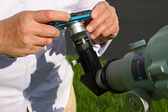 If you don’t have a DSLR camera, don’t worry — you can use your automatic “point-and-shoot” camera to take decent pictures of the eclipse through a filtered telescope. Insert a wide-field eyepiece and hold the camera lens close to it. Use the c