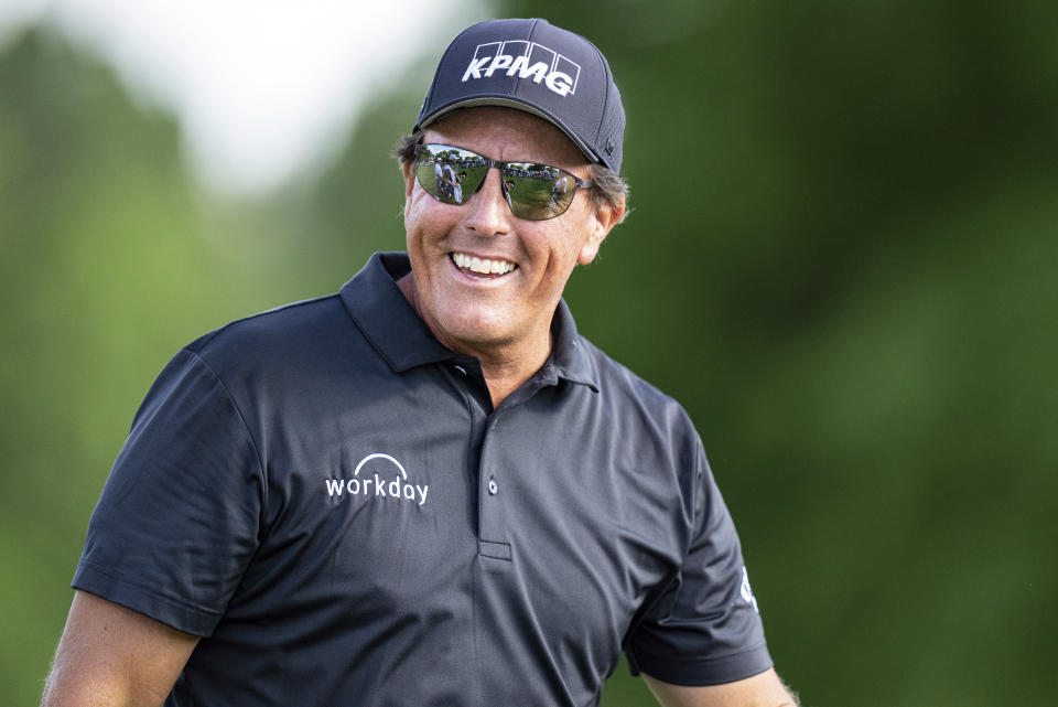 Phil Mickelson smiles after finishing the round on the ninth hole during the first round of the Wells Fargo Championship golf tournament at Quail Hollow Club on Thursday, May 6, 2021, in Charlotte, N.C. (AP Photo/Jacob Kupferman)