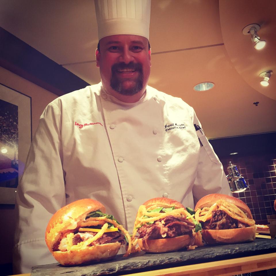 David Harvie, the executive chef at Acrisure Arena, is shown here serving up some pot roast sliders during his time working for the Indiana Pacers of the NBA.