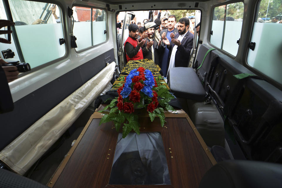 Nangarhar officials hand over the body of Tahir Khan Dawar, a Pakistani police officer, to Pakistani tribal elders in the city of Jalalabad, east of Kabul, Afghanistan, Thursday, Nov. 15, 2018. Pakistan's foreign ministry and the Afghan ambassador have confirmed that the body of a Pakistani police officer who went missing in Islamabad last month has been found in neighboring Afghanistan. Dawar disappeared on Oct. 27 and was presumed abducted by militants. (AP Photo/Mohammad Anwar Danishyar)