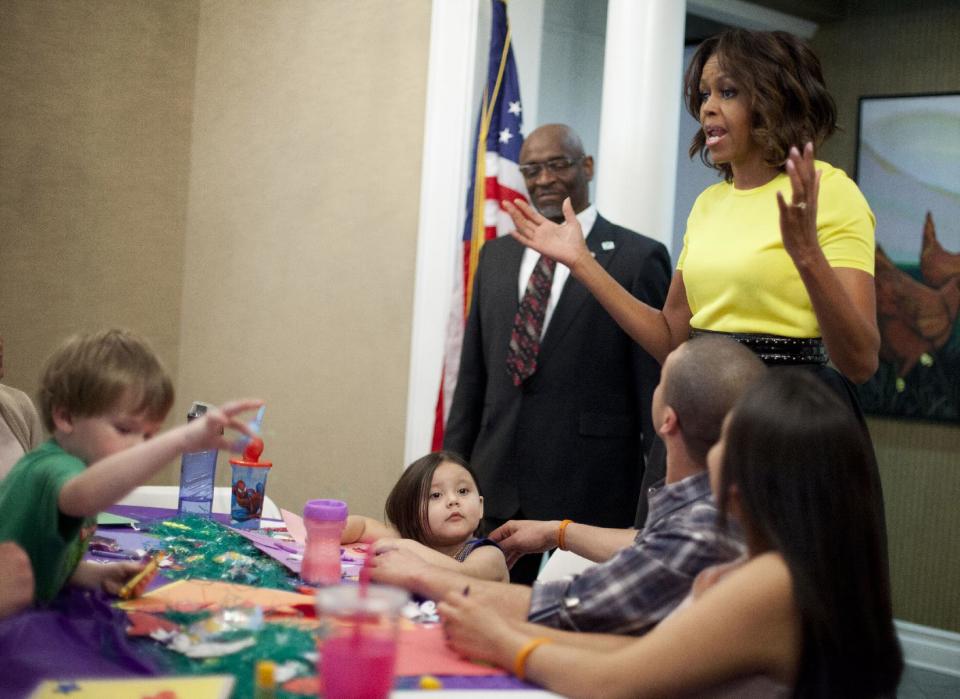 First lady Michelle Obama meets with Wounded Warriors being cared for at the Fisher House at Walter Reed National Military Medical Center in Bethesda, Md., Monday, April 14, 2014. The first lady is participating in a pre-Easter celebration with military families and their children. The Fisher House provides extend stay housing program for family members while their loved ones receiving specialized medical care at Walter Reed. (AP Photo/Pablo Martinez Monsivais)