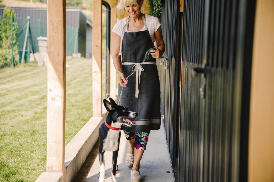 A woman walking a dog