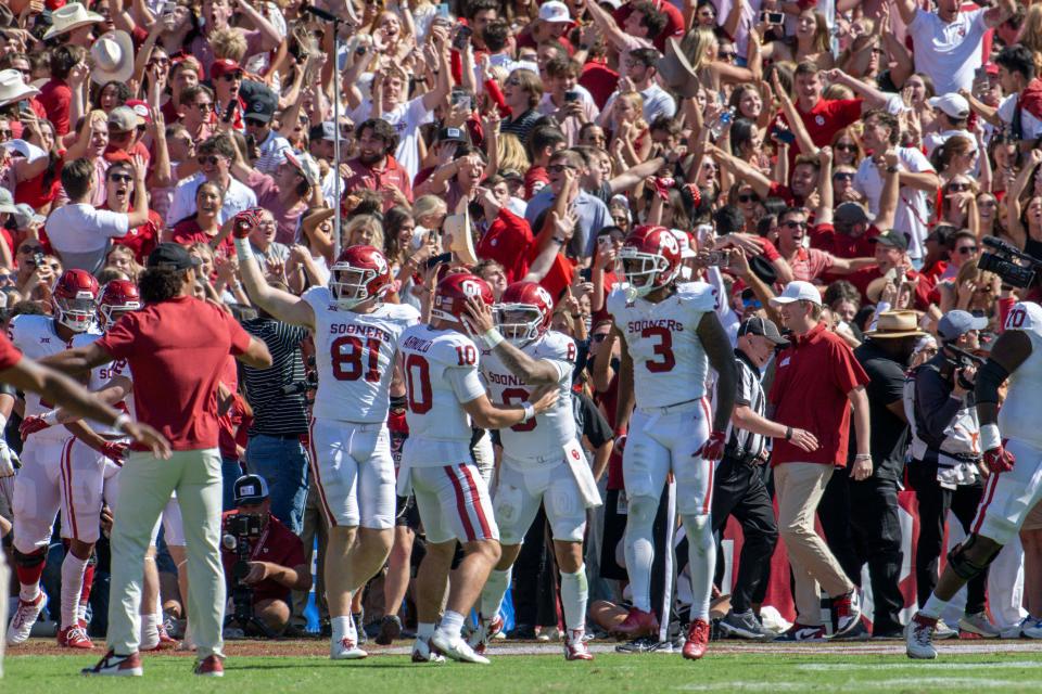 Oklahoma quarterback Dillon Gabriel (8) celebrates with teammates after the game-winning touchdown against Texas at the Cotton Bowl.