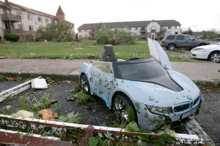 A child's toy car sits among debris from a tornado that touched down overnight in Trotwood, Ohio