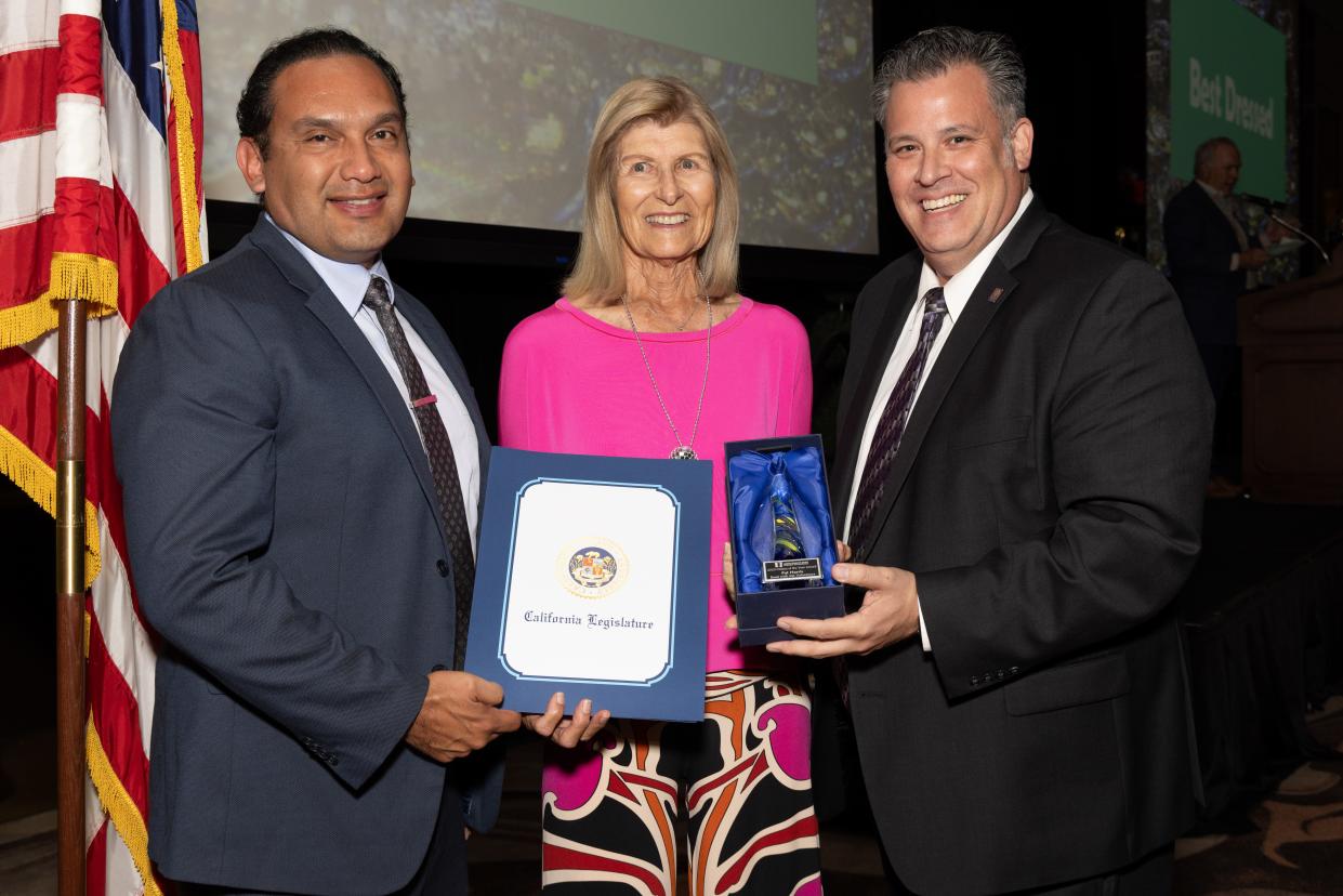 Edwin Gomez, Riverside County Superintendent of Schools, and Sean Webb, Read With Me's executive director, present the annual Palm Desert Area Chamber of Commerce Citizen of the Year award to volunteer Pat Harris.