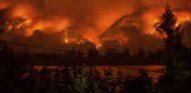 <p>Wildfire as seen from near Stevenson Wash., across the Columbia River, burning in the Columbia River Gorge above Cascade Locks, Ore., Sept. 4, 2017. (Photo: Tristan Fortsch/KATU-TV via AP) </p>