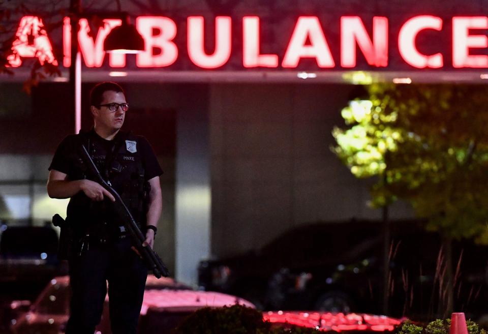 An armed police officer guards the ambulance entrance to the Central Maine Medical Center in Lewiston (AFP via Getty Images)