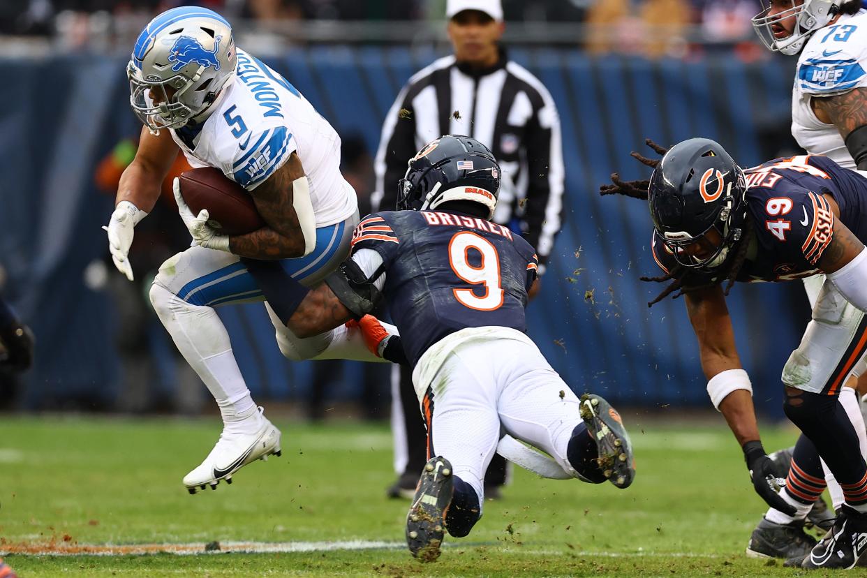 Chicago Bears safety Jaquan Brisker (9) makes a tackle on Detroit Lions running back David Montgomery (5) during the second half at Soldier Field.