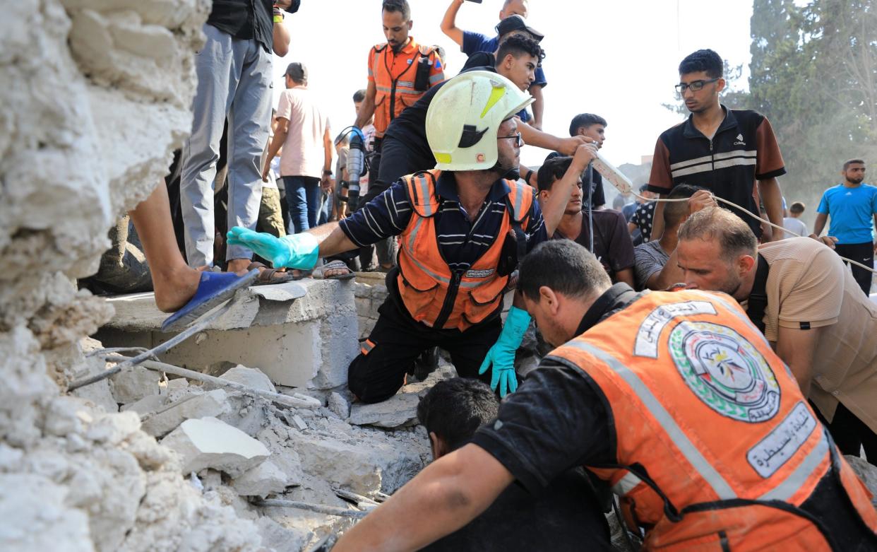 Palestinian residents of the area, together with civil defense teams, carry out search and rescue operations after the Israeli army attacked the Safad School