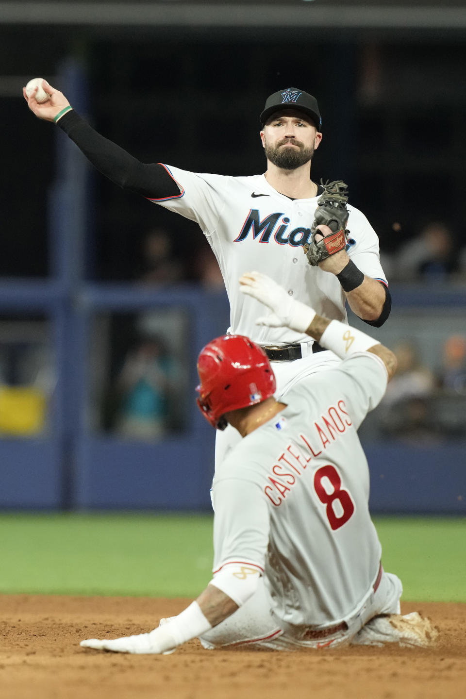 Miami Marlins shortstop Jon Berti tags Philadelphia Phillies' Nick Castellanos (8) at second base but is unable to complete the double play during the ninth inning of a baseball game against the Philadelphia Phillies, Wednesday, Aug. 2, 2023, in Miami. The Marlins defeated the Phillies 9-8 in twelve innings. (AP Photo/Marta Lavandier)