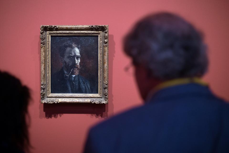 People look a painting by Vincent Van Gogh entitled 'Self-Portrait with Pipe' during the exhibition 'Van Gogh in Provence: Modernizing Tradition' at the Fondation Vincent Van Gogh Arles on May 13, 2016 in Arles, southern France.&nbsp;