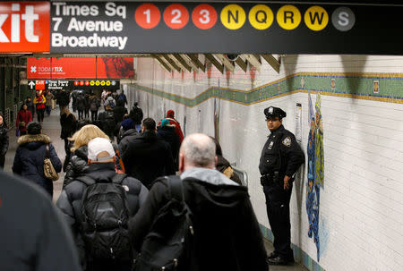 A New York City Police (NYPD) officer stands in the subway corridor, at the New York Port Authority subway station near the site of an attempted detonation the day before, in New York City, U.S. December 12, 2017. REUTERS/Brendan McDermid