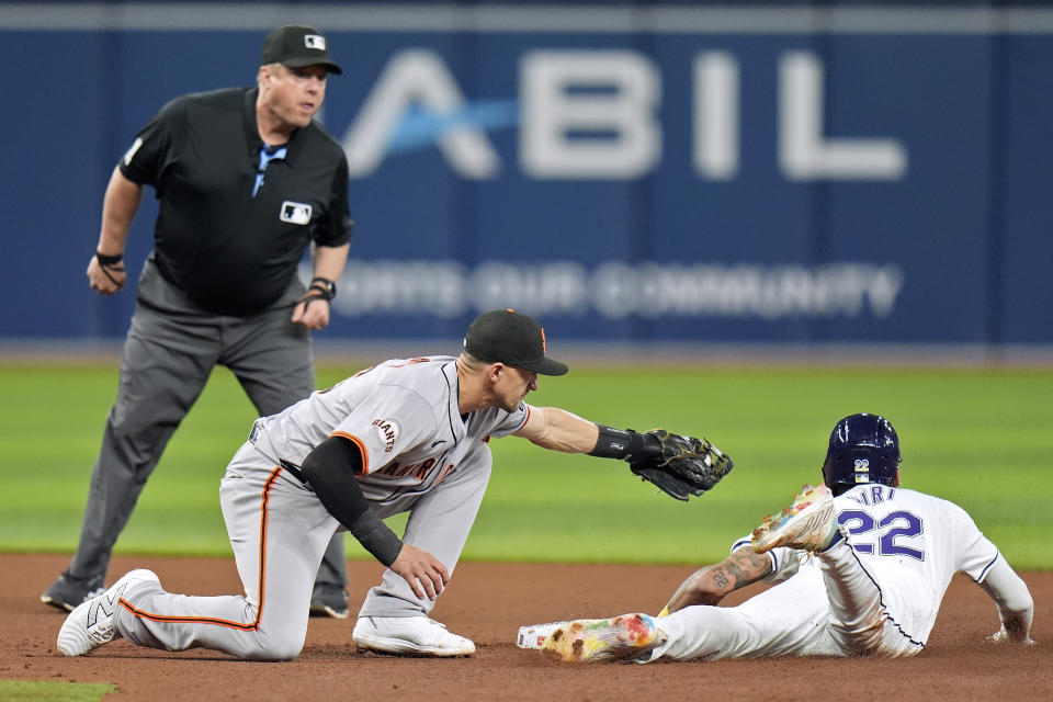 San Francisco Giants shortstop Nick Ahmed tags out Tampa Bay Rays' Jose Siri (22) attempting to steal second base during the fourth inning of a baseball game Friday, April 12, 2024, in St. Petersburg, Fla. (AP Photo/Chris O'Meara)