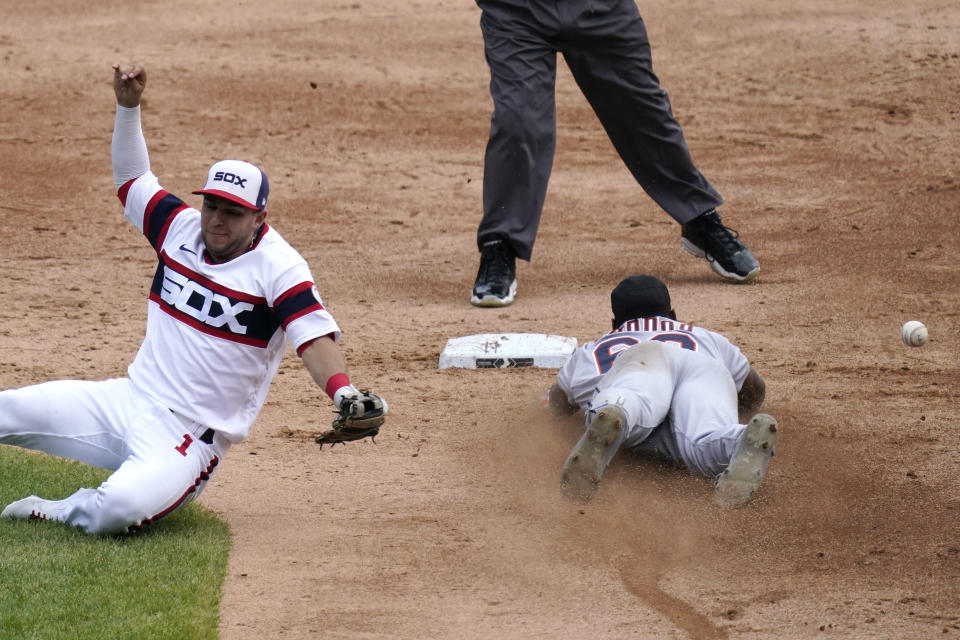 Detroit Tigers' Akil Baddoo, right, steals second as Chicago White Sox second baseman Nick Madrigal, left, cannot make the play on a throwing error by catcher Yasmani Grandal during the third inning of a baseball game in Chicago, Sunday, June 6, 2021. (AP Photo/Nam Y. Huh)