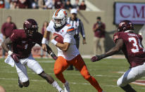 Syracuse quarterback Garrett Shrader (16) runs through Virginia Tech defenders back Chamarri Conner (1) and Alan Tisdale (34) during the first half of of an NCAA college football game in Blacksburg Va., Saturday, Oct. 23 2021. (Matt Gentry/The Roanoke Times via AP)