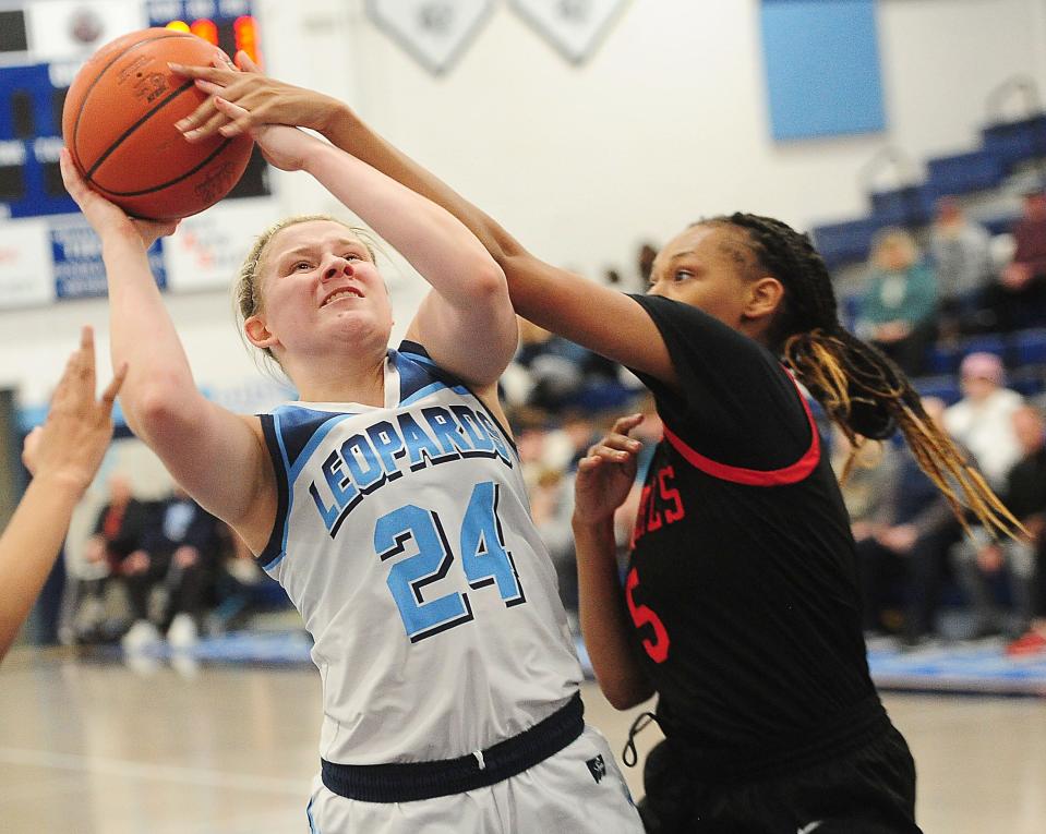 Louisville's Brooke Haren is fouled by Chaney's Ja'Niah Eiland in a Division I sectional final, Thursday Feb. 22, 2024.