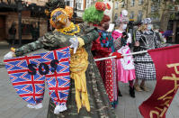 Actors dressed as a pantomime dames pose for photographers as they march on Parliament to demand more support for the theatre sector amid the COVID-19 pandemic in London, Wednesday, Sept. 30, 2020. (AP Photo/Frank Augstein)