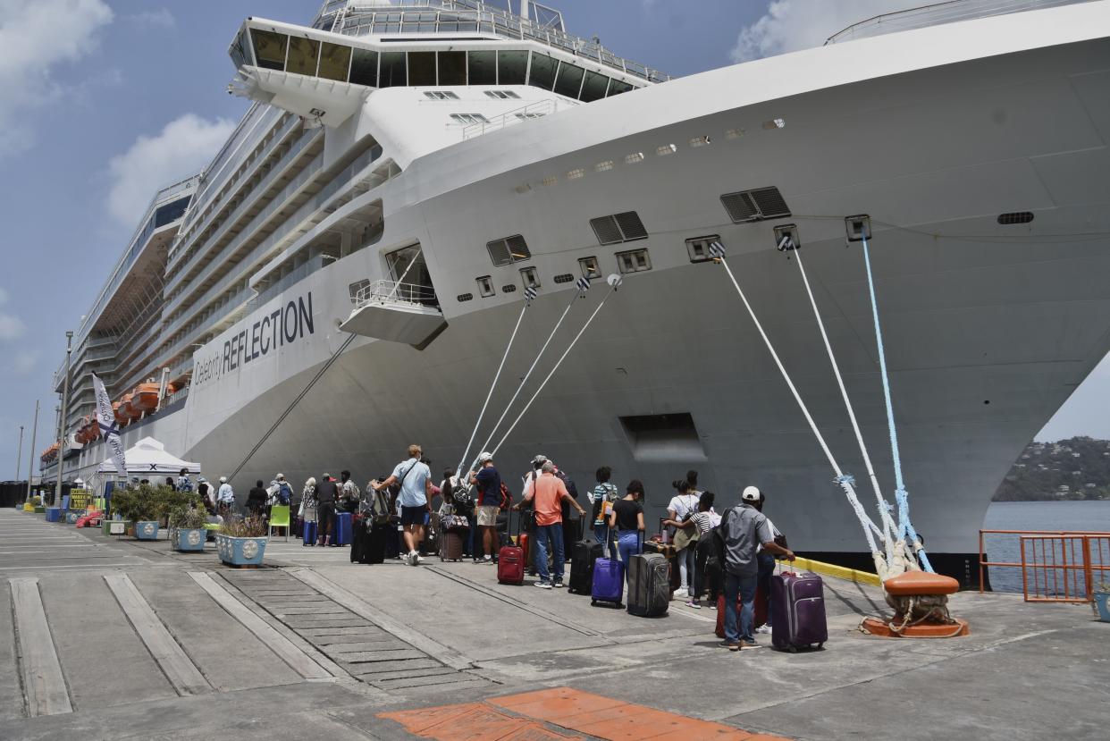British, Canadian and U.S. nationals line up alongside the Royal Caribbean cruise ship Reflection to be evacuated free of charge, in Kingstown on the eastern Caribbean island of St. Vincent on Friday.