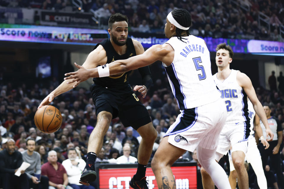 Cleveland Cavaliers guard Max Strus (1) passes against Orlando Magic forward Paolo Banchero (5) during the first half of Game 5 of an NBA basketball first-round playoff series, Tuesday, April 30, 2024, in Cleveland. (AP Photo/Ron Schwane)