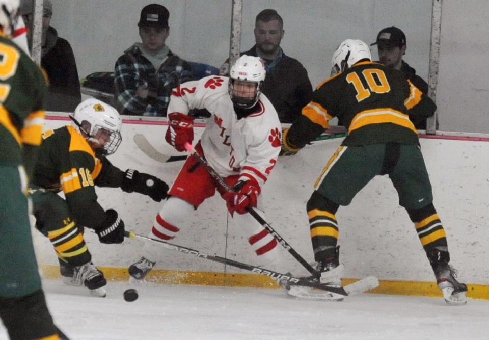 Milton's Barry Burke, center, passes as King Philip's Ethan Sullivan, left, and James Boldy, right, put on the pressure during the Holiday Tournament at Quincy Youth Arena, Tuesday, Dec. 27, 2022.