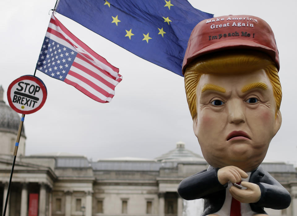 Large puppet portraying Donald Trump is carried as people gather in Trafalgar Square, central London, to demonstrate against the state visit of President Donald Trump, Tuesday, June 4, 2019. Trump will turn from pageantry to policy Tuesday as he joins British Prime Minister Theresa May for a day of talks likely to highlight fresh uncertainty in the allies' storied relationship. (AP Photo/Tim Ireland)