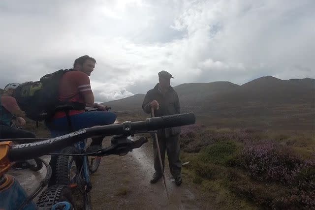 <p>McTrail Rider/Youtube</p> King Charles meets cyclists while hiking on Scotland