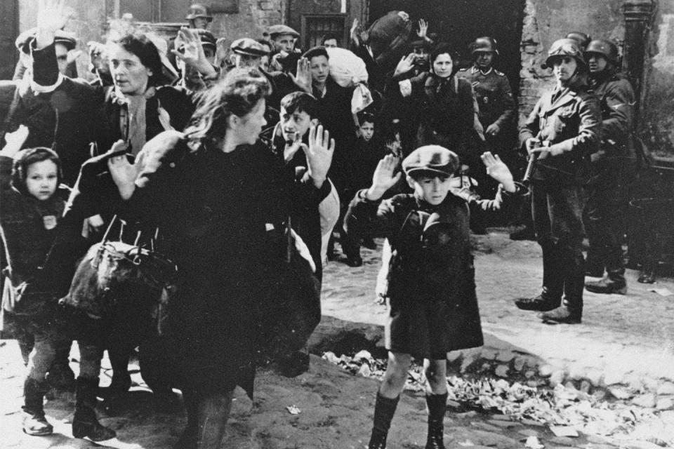 Jewish people being escorted from the Warsaw Ghetto, from which Mala escaped, by German soldiers. AP