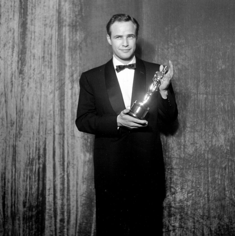 PHOTO: Best actor winner Marlon Brando poses backstage at the 27th Academy Awards holding an Oscar for his performance in the movie 'On The Waterfront' on March 30, 1955 in New York City. (Michael Ochs Archives/Getty Images, FILE)