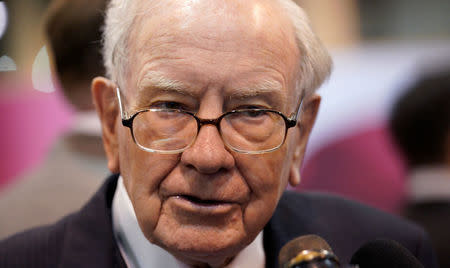 Warren Buffett, CEO of Berkshire Hathaway Inc, talks to a reporter in the exhibit hall at the company's annual meeting in Omaha, Nebraska, U.S., May 5, 2018. REUTERS/Rick Wilking