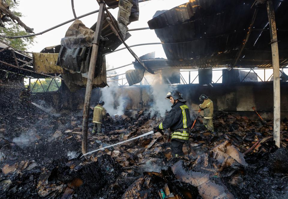 Firefighters work to extinguish fire at a warehouse destroyed in shelling in the course of Russia-Ukraine conflict in Donetsk (REUTERS)
