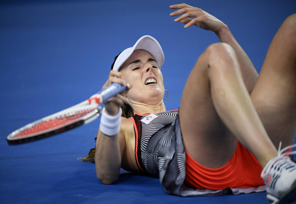 France's Alize Cornet reacts after falling during her second round match against United States' Venus Williams at the Australian Open tennis championships in Melbourne, Australia, Thursday, Jan. 17, 2019. (AP Photo/Andy Brownbill)