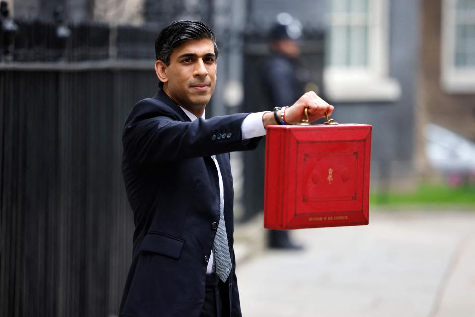 Rishi Sunak poses with the Budget BoxAFP via Getty Images